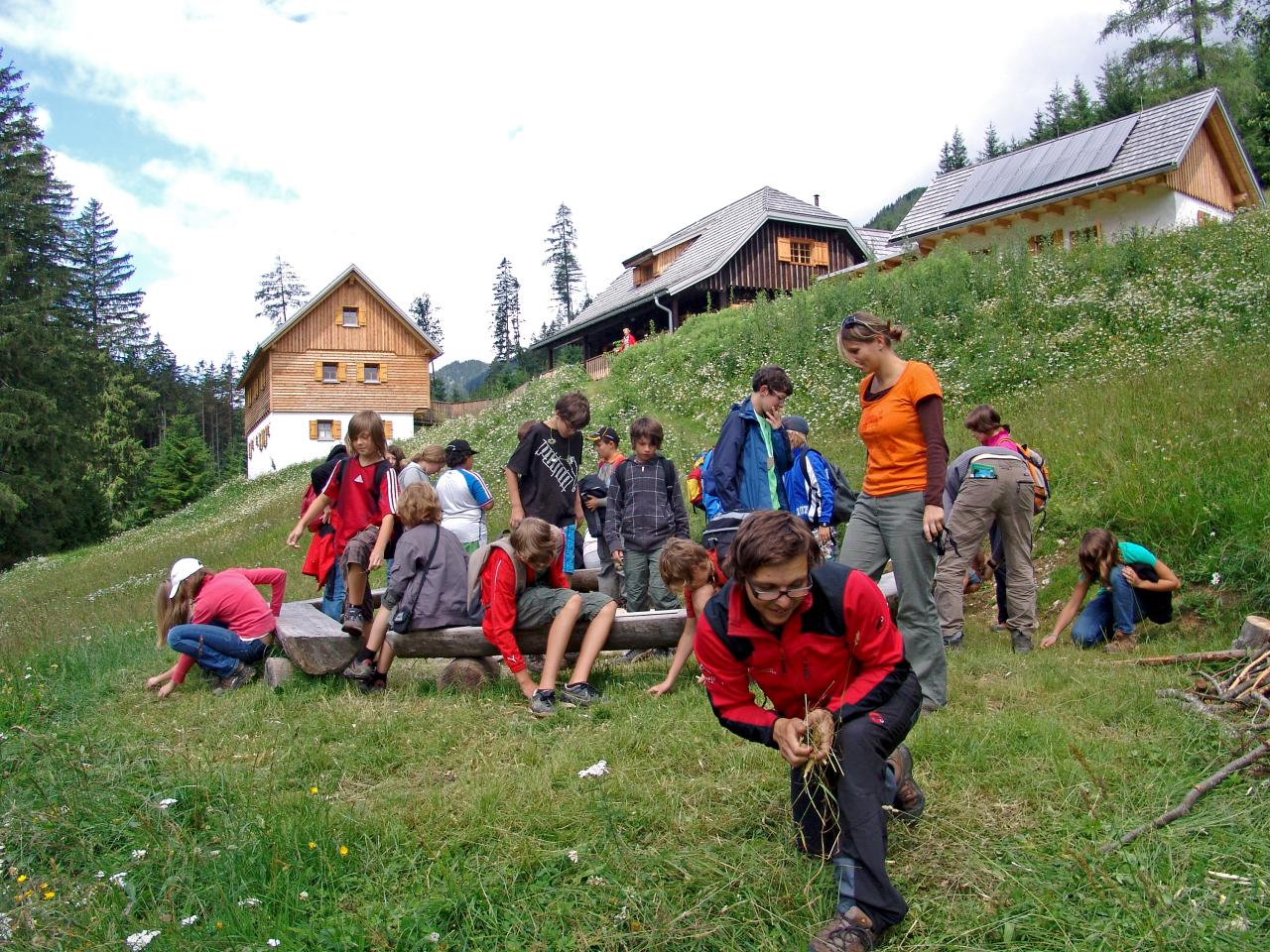 Adults prepare a campfire with pupils