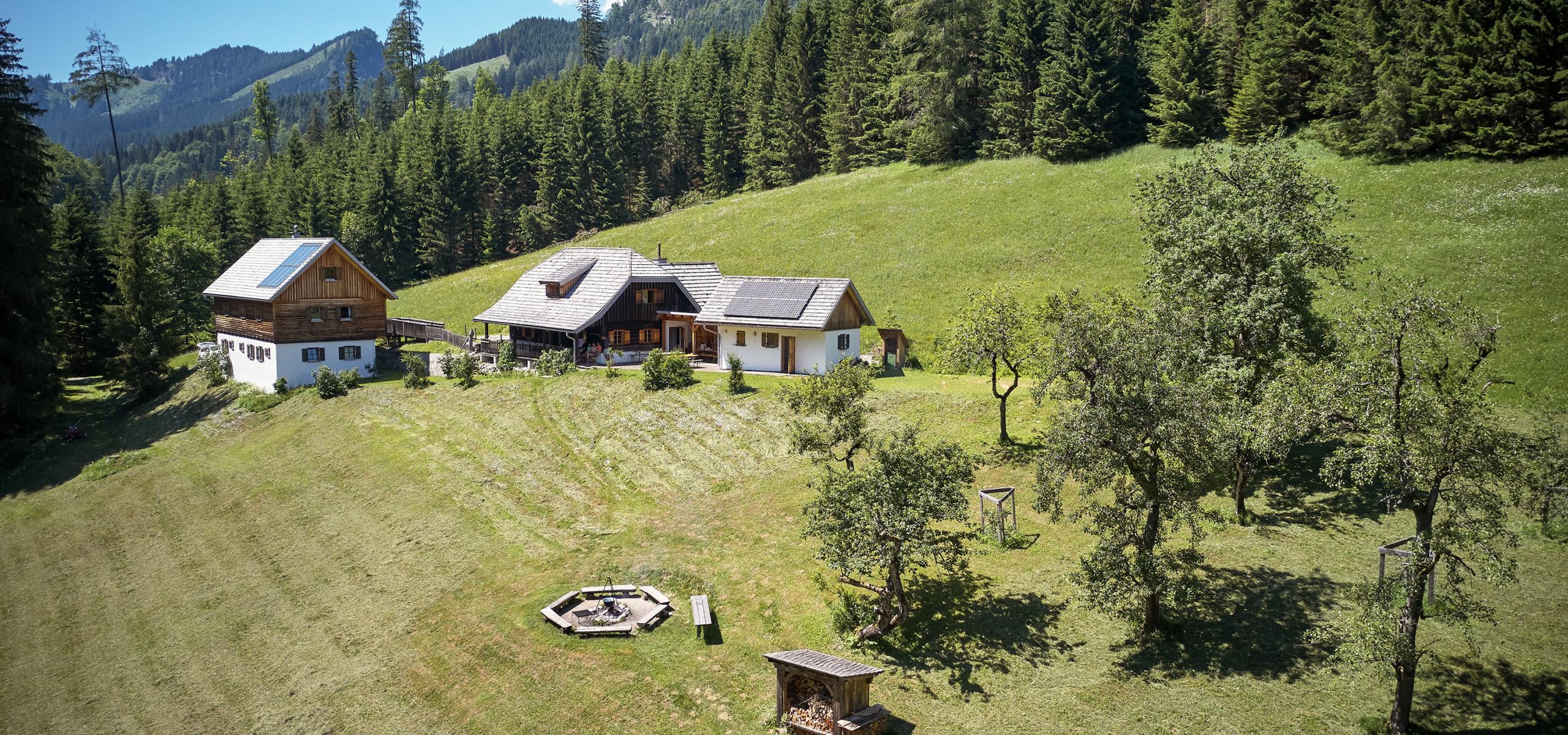 Aerial view shows building ensemble and campfire site from the Kalkalpen National Park Wildniscamp