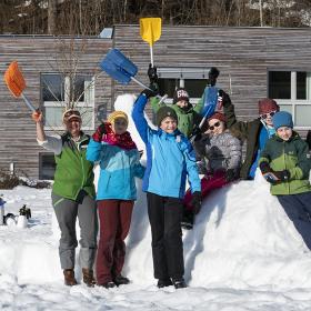 Ranger and a group of children build a snow sculpture