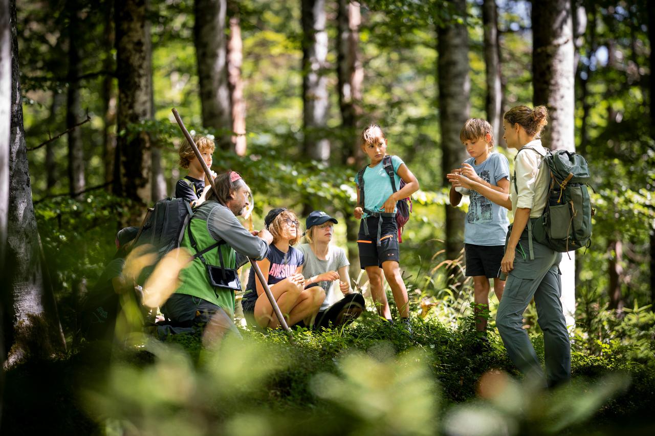 National Park ranger talking to a group of children in the forest