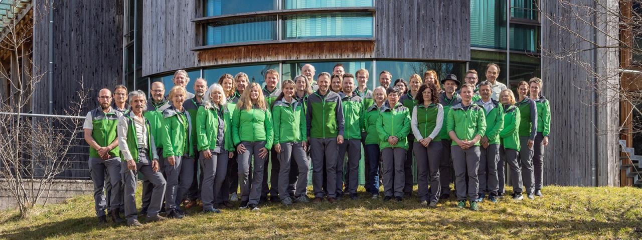 Group photo of Kalkalpen National Park employees in front of Nationalpark Zentrum Molln.