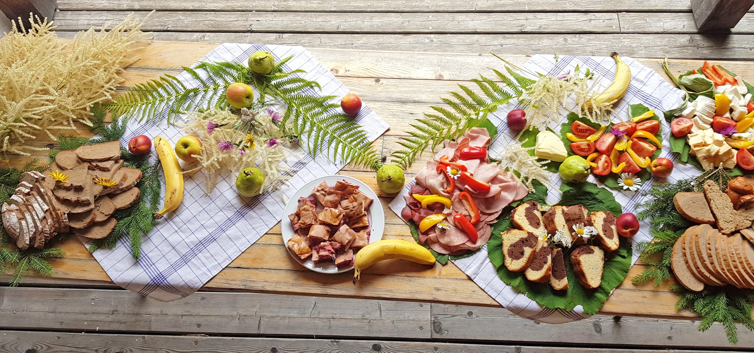 Snack buffet decorated with flowers and ferns