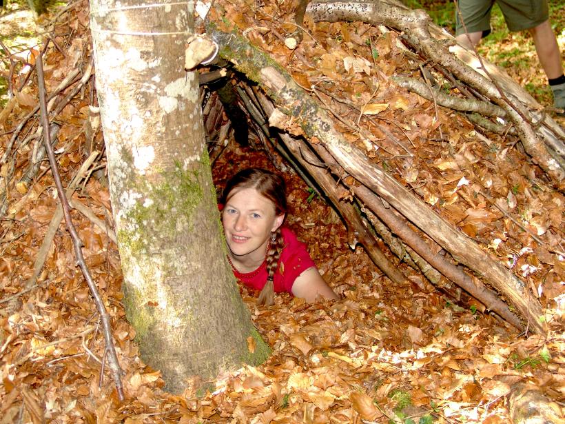 A woman has retreated into a duck made of branches and leaves