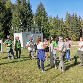 National Park employee explains a measuring station to a group