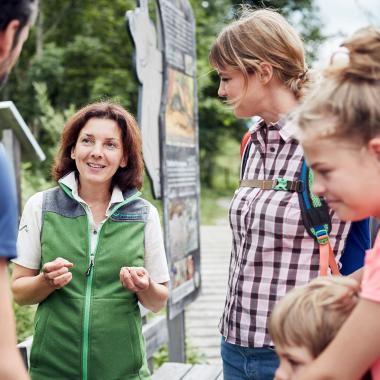 National Park ranger talks to a family with children