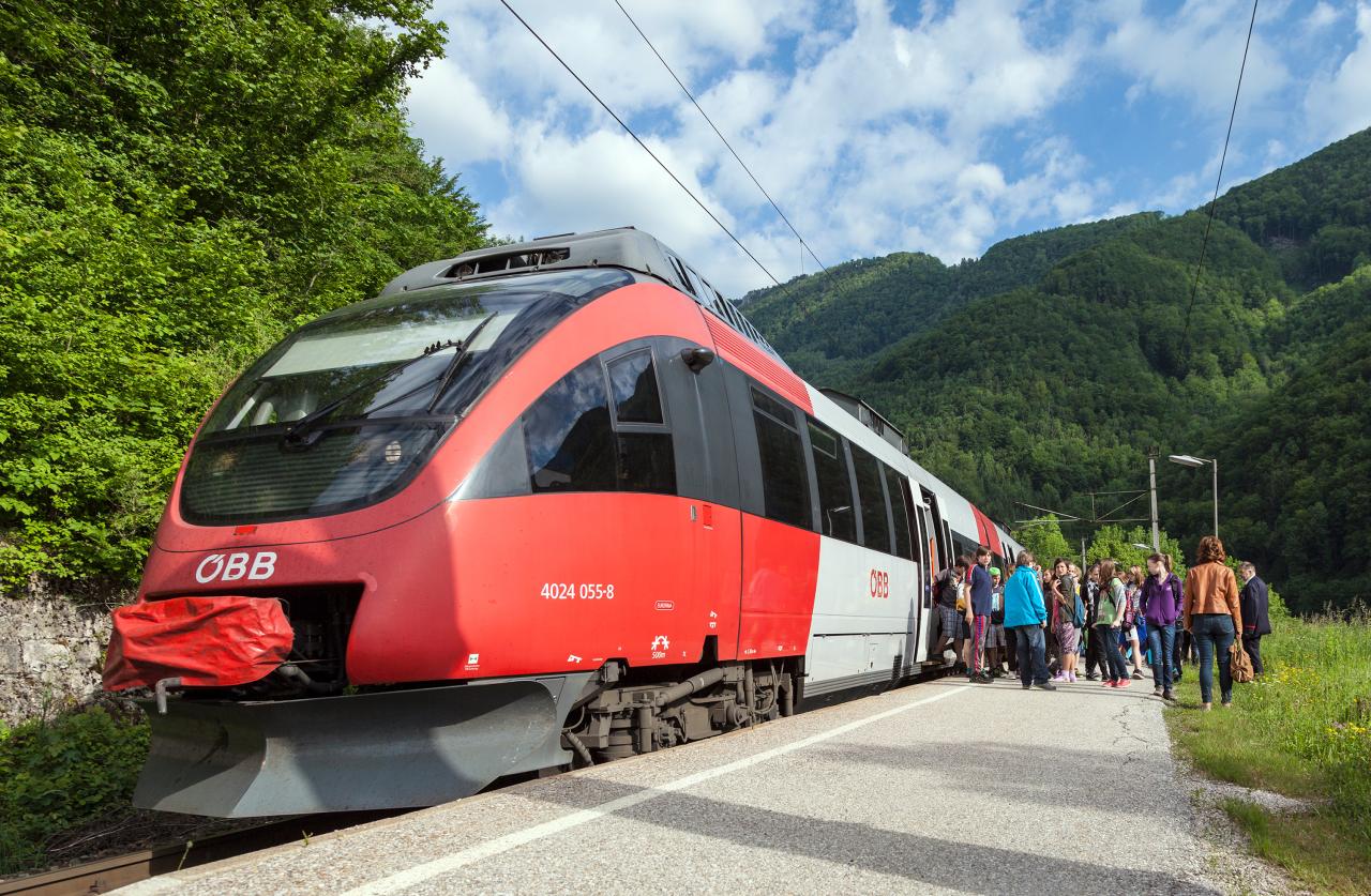 People get off a train and gather on the platform